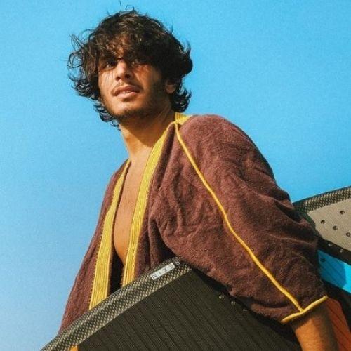 Omar Farooq wearing beach bisht classic bathrobe brown color when he surfing at the beach