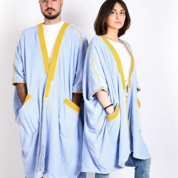 Woman wearing Beach Bisht classic bathrobe baby blue color small size men wearing bathrobe baby blue color medium size from terry towel beach cover up collections