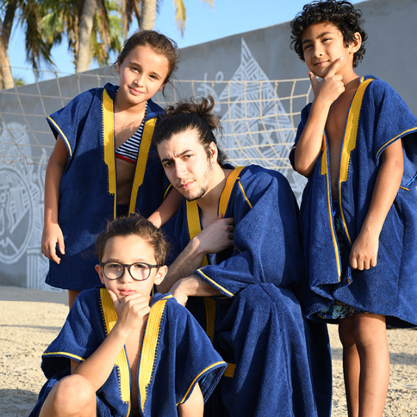 Kids are wearing Beach Bisht kids hoodie  bathrobe, all wearing navy color small, dad wearing Beach Bisht classic bathrobe navy color large size