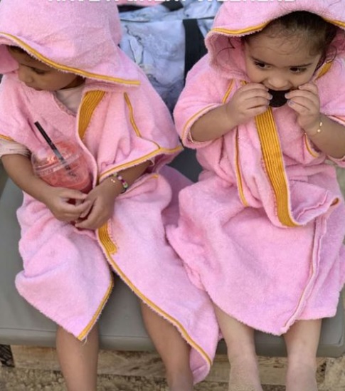 Toddler twins are wearing Beach Bisht kids hoodie bathrobe pink color, small size from beach bisht terry towel beach cover up kimono collections